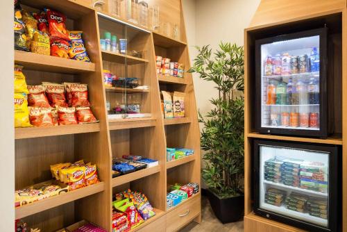 a food pantry with a refrigerator filled with food at Microtel Inn & Suites by Wyndham Val-d Or in Val-dʼOr