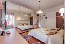 a living room with two beds and a large mirror at B&B La Terrazza in Rome