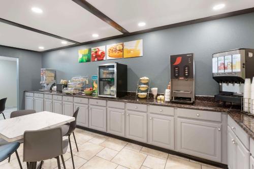 a fast food restaurant with a counter with machines at Quality Inn Newton at I-80 in Newton