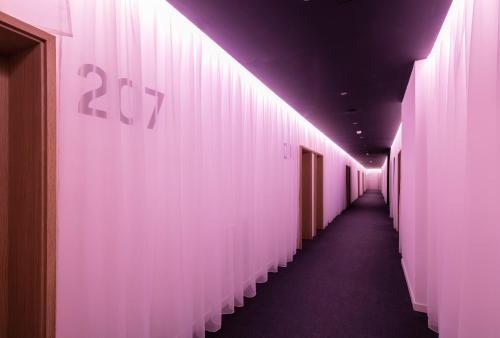 a hallway with pink lights on the wall at Pytloun Grand Hotel Imperial in Liberec