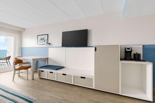 a room with a desk with a tv on top at Hilton Garden Inn Ocean City Oceanfront in Ocean City