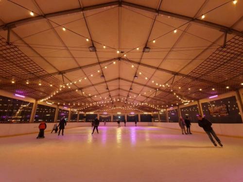 a group of people skating on an indoor ice rink at Hotel 365 in Kielce