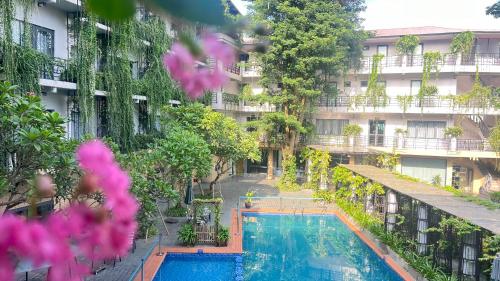 a hotel with a swimming pool in front of a building at X Hotel Thái Nguyên in Thái Nguyên