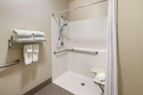 a bathroom with a shower and a toilet with towels at Best Western Plus Kalispell/Glacier Park West Hotel & Suites in Kalispell