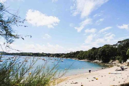 a view of a beach with boats in the water at The Cuckoo's Retreat - Luxurious home with private garden & jacuzzi in Kenwyn