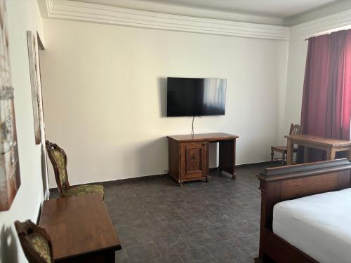 a hotel room with a bed and a flat screen tv at Apartmány LAGUNA in Kopřivnice