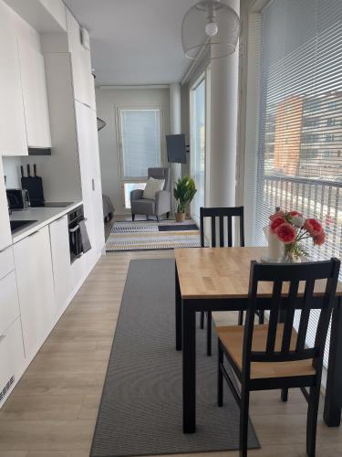 a kitchen and living room with a table and chairs at Snowflake Suites VII in Rovaniemi
