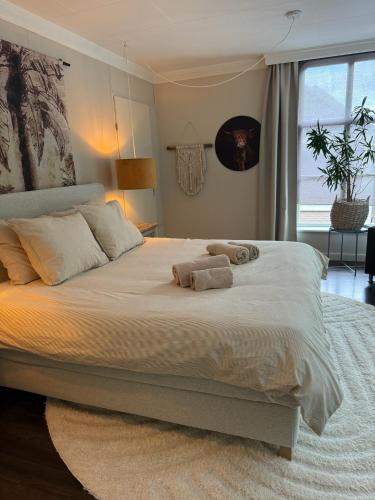 a bedroom with a large bed with towels on it at Appartement Nu in Eersel