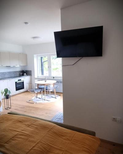 a bedroom with a flat screen tv on the wall at Apartments in Graz in Graz