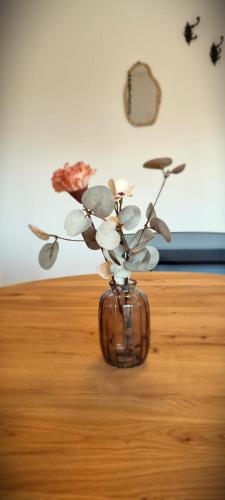 a vase with flowers in it on a table at Apartments in Graz in Graz