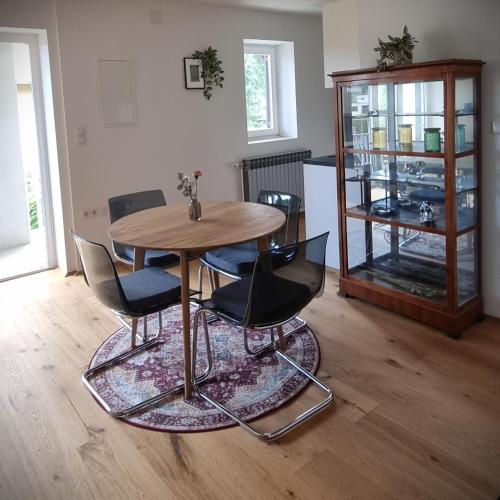a dining room with a wooden table and chairs at Apartments in Graz in Graz