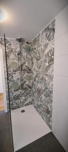 a room with a wall with a mural of leaves at Apartments in Graz in Graz