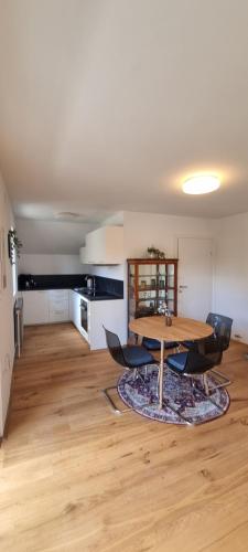 a dining room with a wooden table and chairs at Apartments in Graz in Graz
