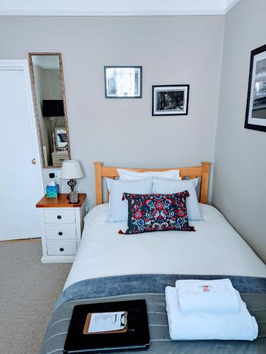 a bedroom with a bed with a tray on it at Alexander Lodge in Bournemouth