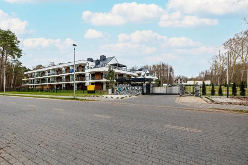 a large building on the side of a road at Modern Apartment With Private Garden Międzywodzie by Renters Prestige in Międzywodzie