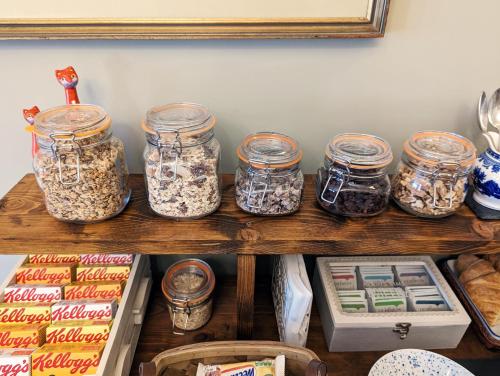 a shelf filled with jars of food on a counter at Alexander Lodge in Bournemouth