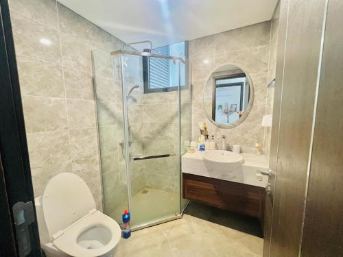 a bathroom with a shower and a toilet and a sink at Cosy homestay and apartment in Hai Phong