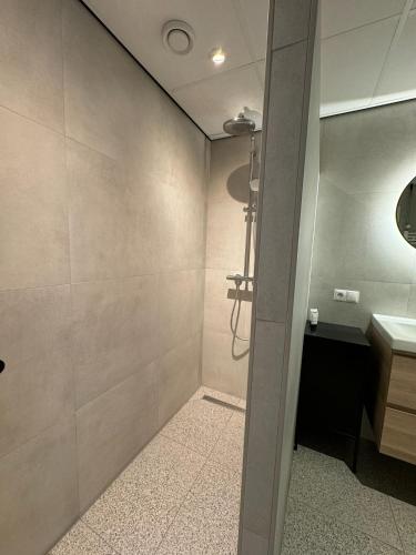 a bathroom with a shower and a sink at Appartement Nu in Eersel