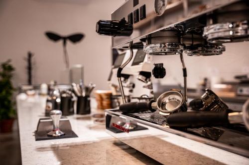 a kitchen with a counter with a coffee machine at Tiszavirág Szeged in Szeged