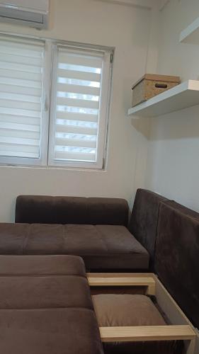 a living room with a couch and a window at Studio Mili in Malovići
