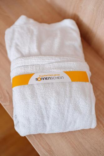 a white towel sitting on top of a table at Sonnenschein Hotel & Apartments in Heilbad Heiligenstadt