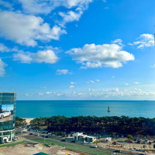 a view of the ocean from a building at Best Louis Hamilton Hotel Haeundae in Busan