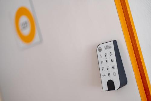 a remote control on a wall next to a door at Sonnenschein Hotel & Apartments in Heilbad Heiligenstadt