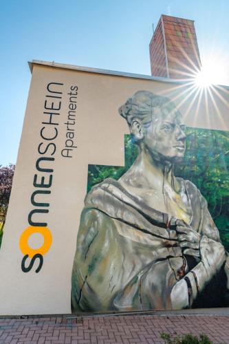a statue of a woman on the side of a building at Sonnenschein Hotel & Apartments in Heilbad Heiligenstadt