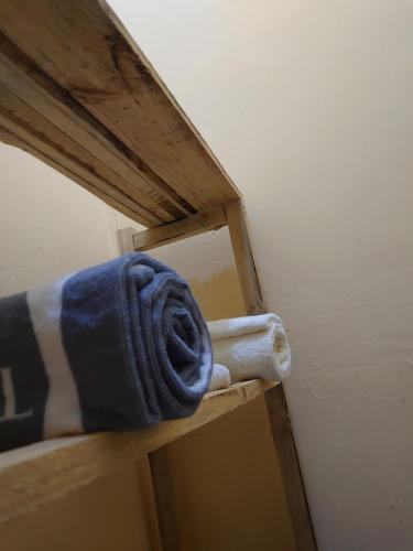 a towel sitting on top of a wooden shelf at Sero Safaris Hostel in Arusha