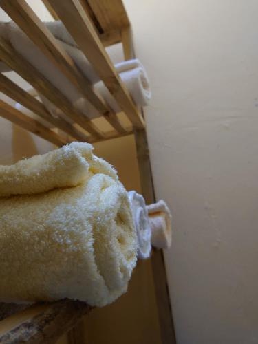 a stuffed teddy bear sitting on top of a wooden rack at Sero Safaris Hostel in Arusha