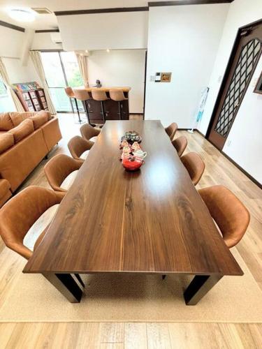 a large wooden table in a room with chairs at 池袋駅まで電車で7分 4LDK98m2 in Tokyo