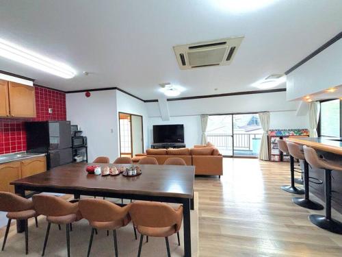 a kitchen and a living room with a table and chairs at 池袋駅まで電車で7分 4LDK98m2 in Tokyo