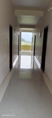 a hallway in a building with a view of a field at Valley View Homestay in Dirang Dzong