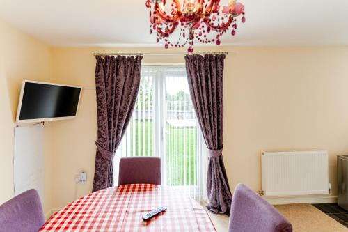 a dining room with a table and a window at 4 Bedroom Detached, Wi-Fi, Parking, stunning views in Newcastle under Lyme