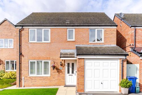 a brick house with a white garage at 4 Bedroom Detached, Wi-Fi, Parking, stunning views in Newcastle under Lyme