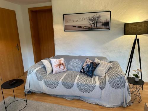 a couch with pillows on it in a room at Wohnung in zentraler und trotzdem ruhiger Lage, Balzers in Balzers