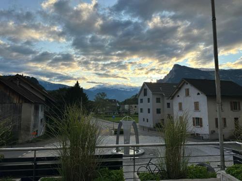 a view of a street with mountains in the background at Wohnung in zentraler und trotzdem ruhiger Lage, Balzers in Balzers