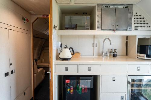 an rv kitchen with a refrigerator and a sink at Aerotel in Hoedspruit