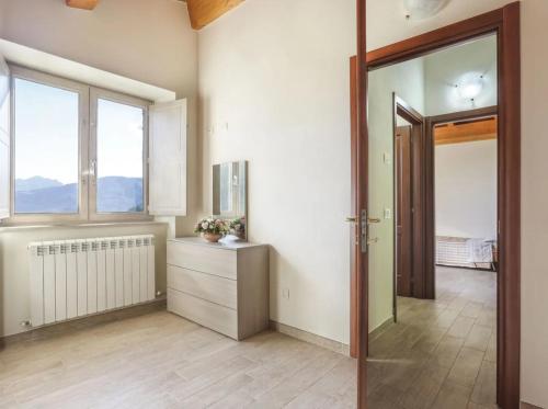 an empty room with a door and a window at Capanna - Agriturismo La Pazienza in Magnano