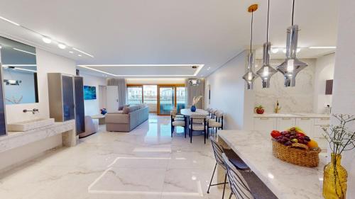 a kitchen and living room with a table with fruit on it at KING DAVID RESIDENCES - Pool & Gym in Jerusalem