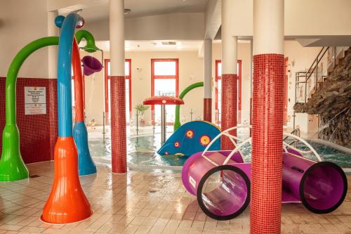 a water park with a pool and a playground at Vulkán Wellness Hotel & Camping in Celldömölk