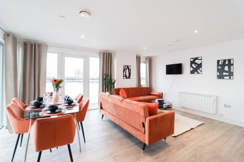 a living room with a couch and a table at Spacious and Sunny Flat l River Balcony View ! in London