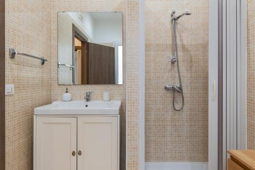 a bathroom with a sink and a shower with a mirror at Rosa dei Venti Grottaglie in Grottaglie