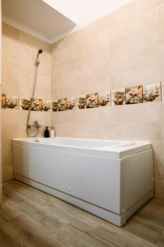 a white tub in a bathroom with a shower at Zen Studio 1 with balcony in Bucharest