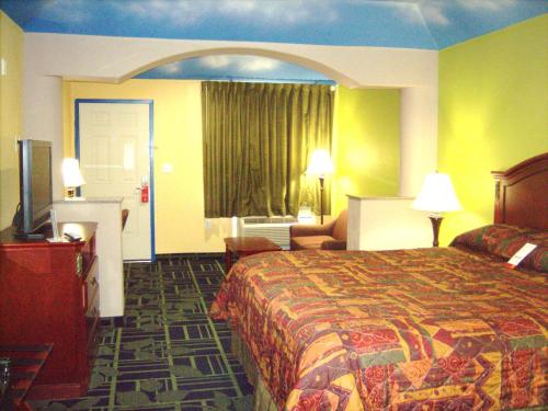 a hotel room with a bed and a television at Regency Inn Porter in Porter
