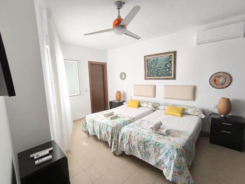 ein Schlafzimmer mit einem Bett und einem Deckenventilator in der Unterkunft Casa Cati in La Herradura