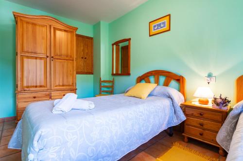 a bedroom with a bed and a wooden cabinet at Casa Lino in Culla