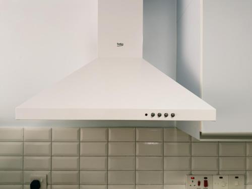 a white stove top oven in a kitchen at Cozy & Modern Sea View Studio in Bogaz, Iskele, Cyprus in Boğaz