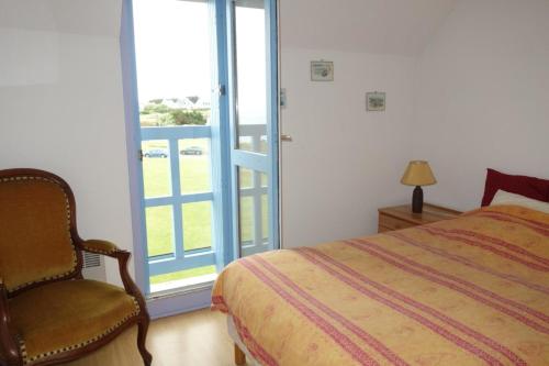 une chambre avec un lit, une chaise et une fenêtre dans l'établissement Nice T3 with terrace and sea view, à Saint-Malo