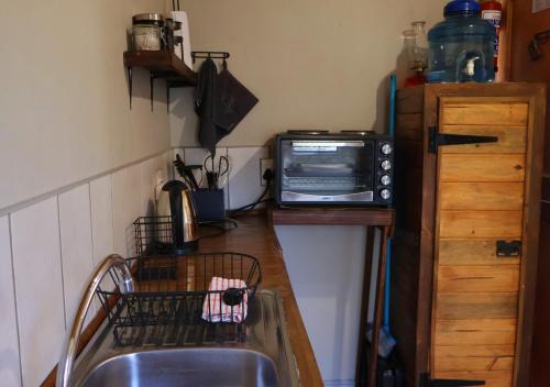 a kitchen with a sink and a microwave on a counter at Fossil Hills in McGregor